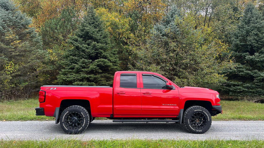 Robust 5-inch oval side steps with a distinct black textured finish, tailored for Chevrolet & GMC Double cab pickups, featuring a molded Fishbone grip step pad.