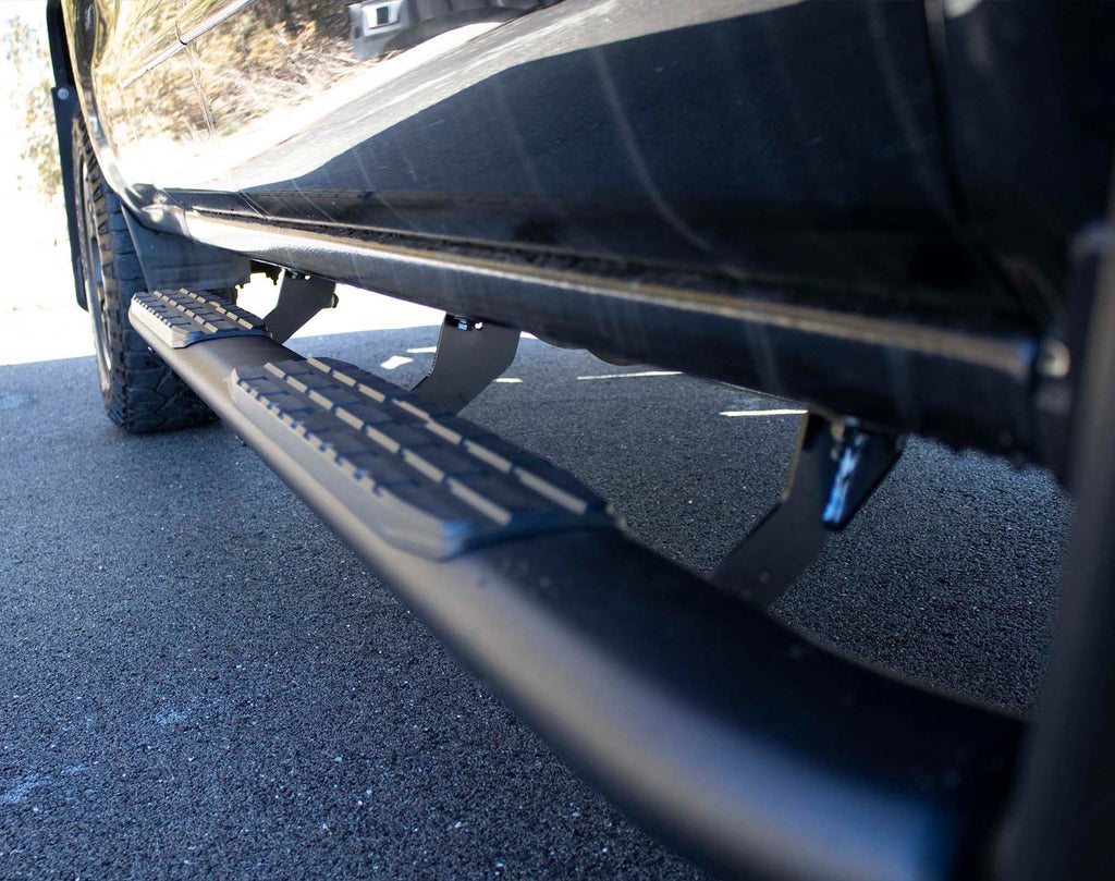 Robust 5-inch oval side steps with a distinct black textured finish, tailored for Chevrolet & GMC Double cab pickups, featuring a molded Fishbone grip step pad.