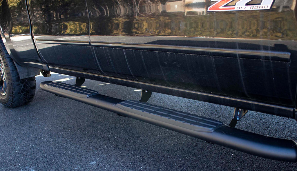 Robust 5-inch oval side steps with a distinct black textured finish, tailored for Chevrolet & GMC Double cab pickups, featuring a molded Fishbone grip step pad.