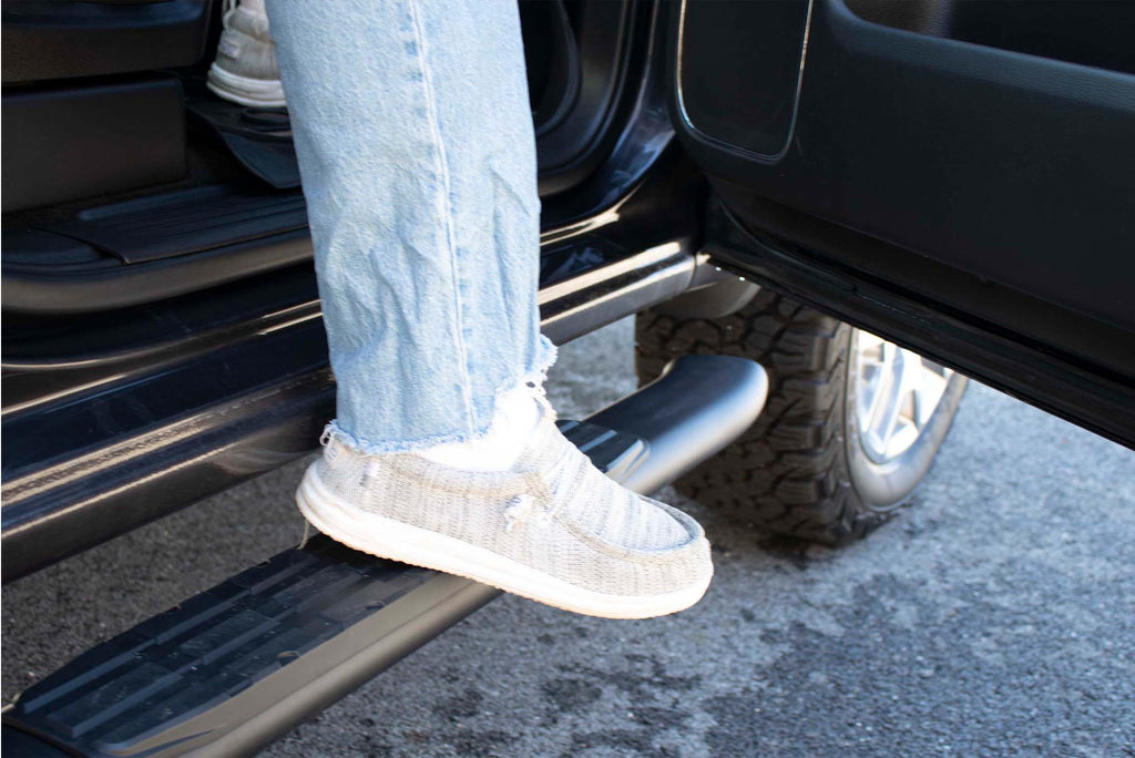 Robust 5-inch oval side steps with a distinct black textured finish, tailored for Chevrolet & GMC Double cab pickups, featuring a molded Fishbone grip step pad.